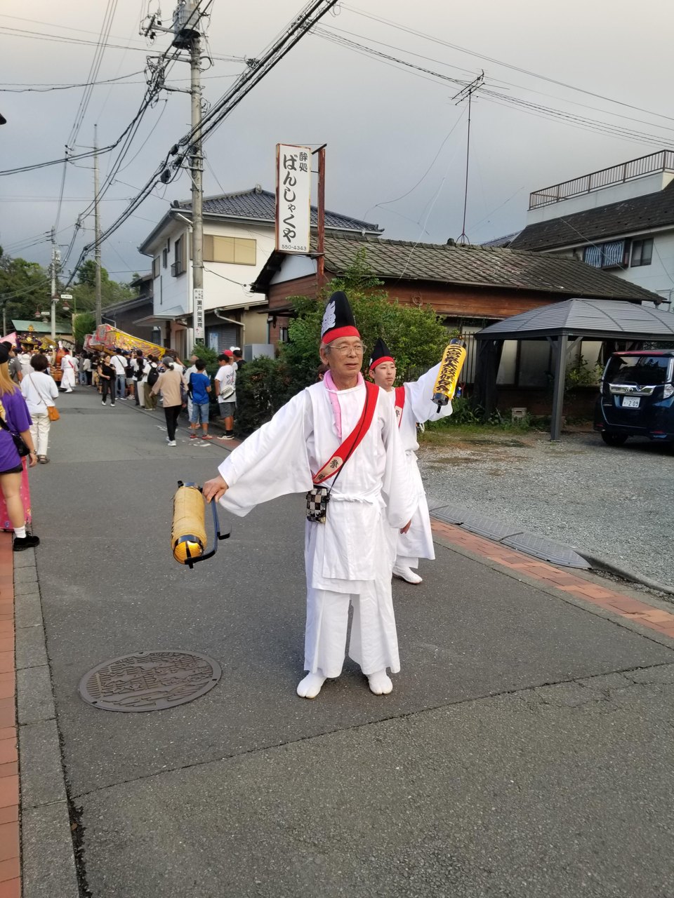 白装束で御神輿の行列を先導する人